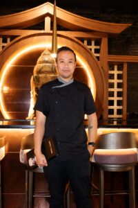 Head Chef Oliver Guan standing inside Sake a Gogo Japanese restaurant in Louisville’s NuLu neighborhood.