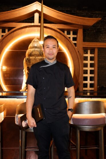 Head Chef Oliver Guan standing inside Sake a Gogo Japanese restaurant in Louisville’s NuLu neighborhood.